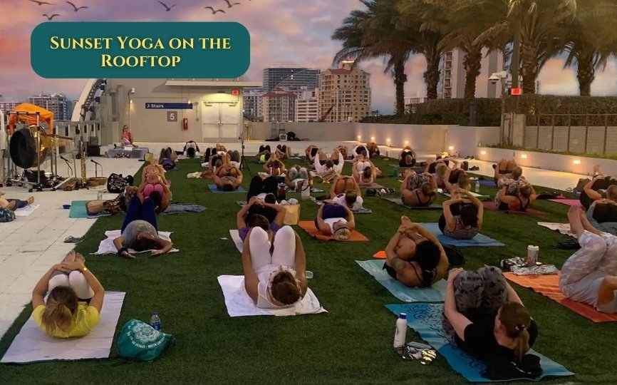 A slightly tilted, low-angle shot of someone mid-downward dog on a rooftop with a half-drunk coffee nearby,